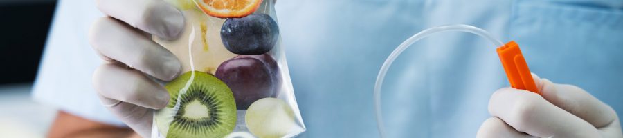 Male,Doctor,Holding,Saline,Bag,With,Fruit,Slices,Inside,In